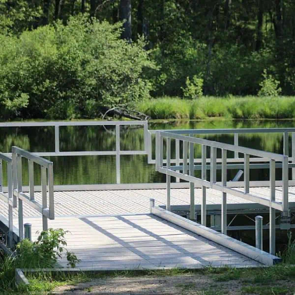 Pond dock with stainless steel hand railings